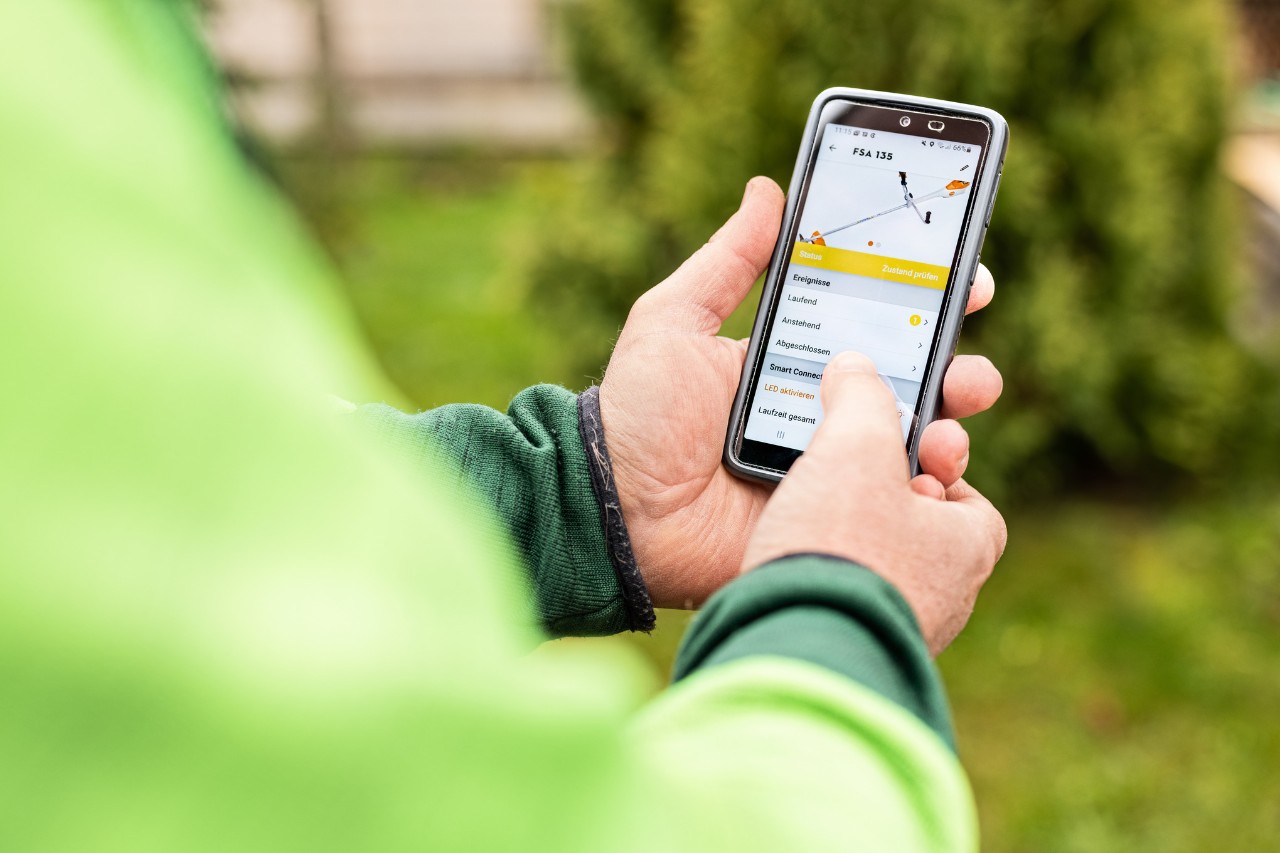 Zbliżenie na osobę obsługującą aplikację STIHL connected na smartfonie